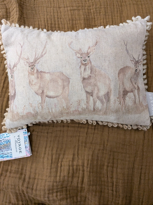 Decorative pillow with deer pattern on a brown surface