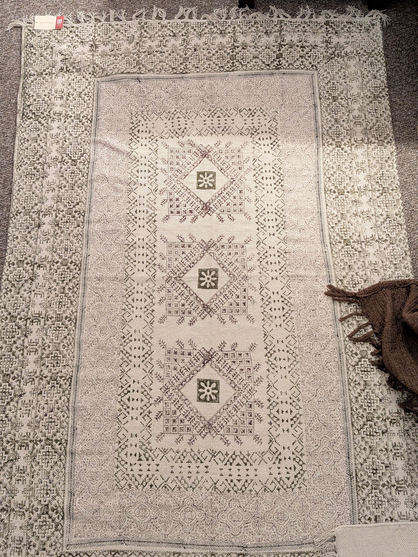 Decorative rug with intricate patterns on a plain background
